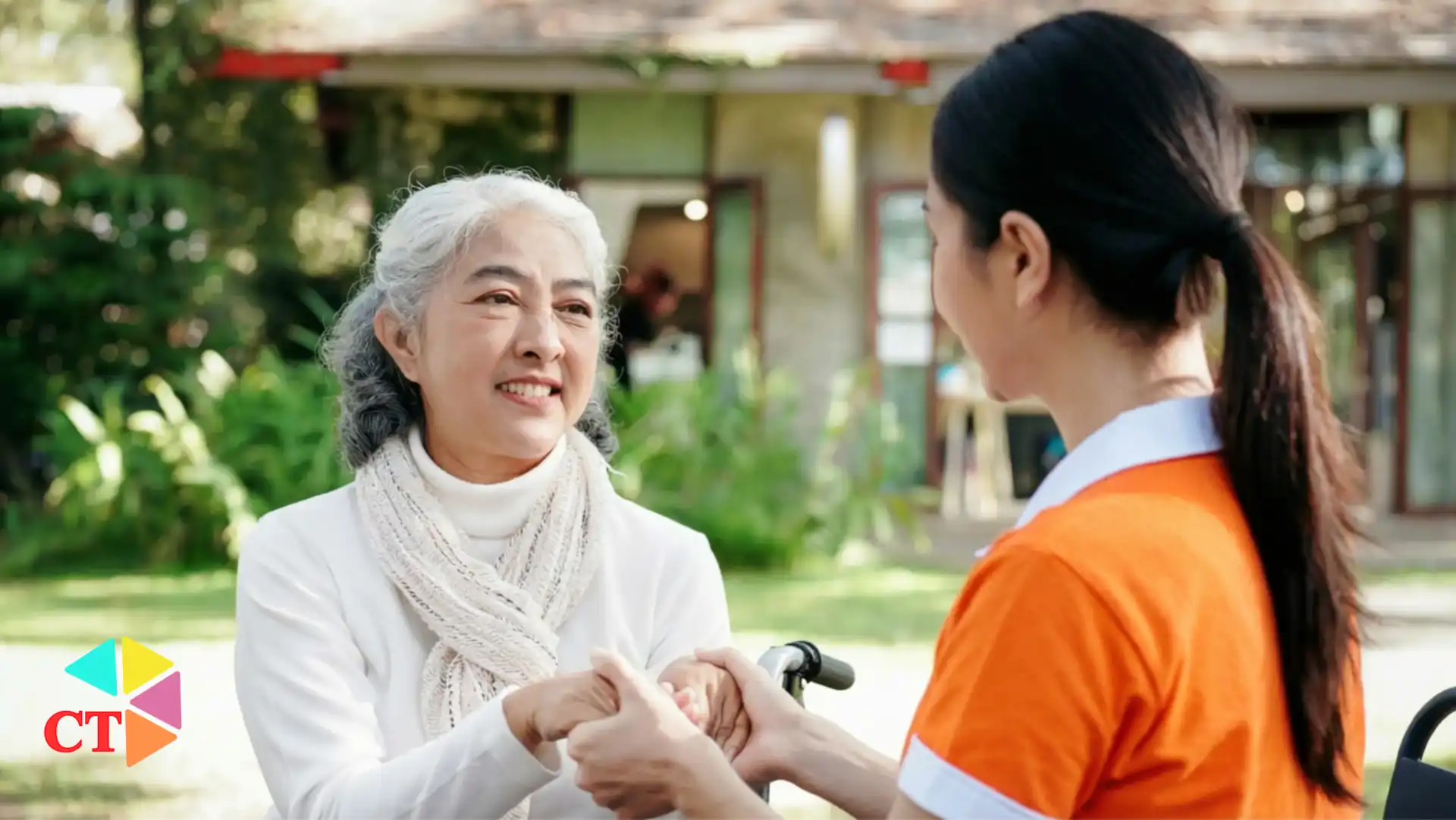 Professional elderly caregiver assisting a senior at home